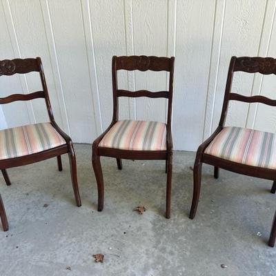 Three upholstered ladder back chairs