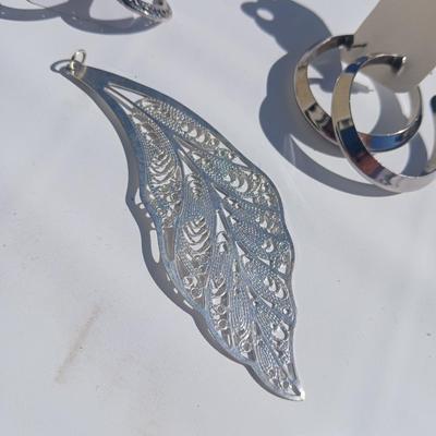 Silver toned earrings, necklaces, pendants and more - all silver in color