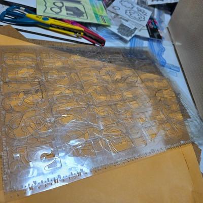 Box of crafting supplies - stencils - die cuts - scissors and more