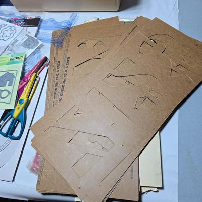 Box of crafting supplies - stencils - die cuts - scissors and more