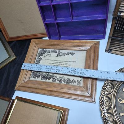 Small trinket shelves, picture frames, and a wall clock