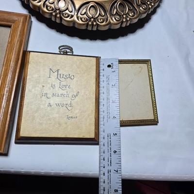 Small trinket shelves, picture frames, and a wall clock