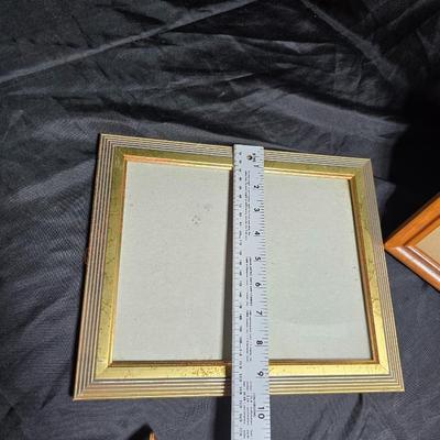 Small trinket shelves, picture frames, and a wall clock