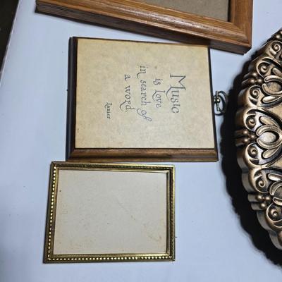 Small trinket shelves, picture frames, and a wall clock