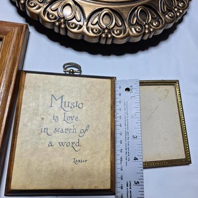 Small trinket shelves, picture frames, and a wall clock