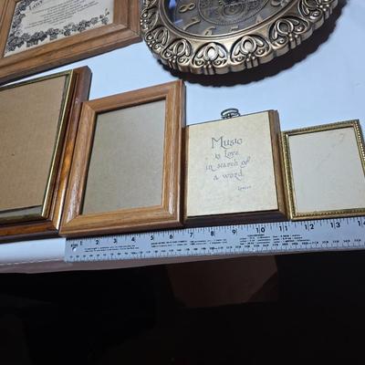 Small trinket shelves, picture frames, and a wall clock