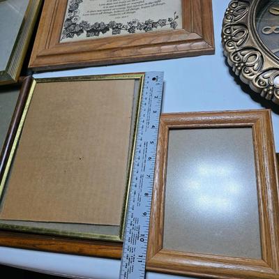 Small trinket shelves, picture frames, and a wall clock