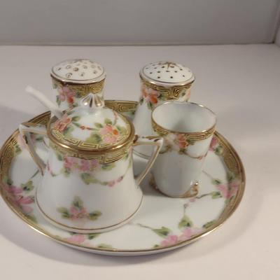 Sale Photo Thumbnail #473: Vintage Hand Painted Nippon Condiment Set- Seven Pieces.  Cup has chipping at rim- please see all pictures for condition.