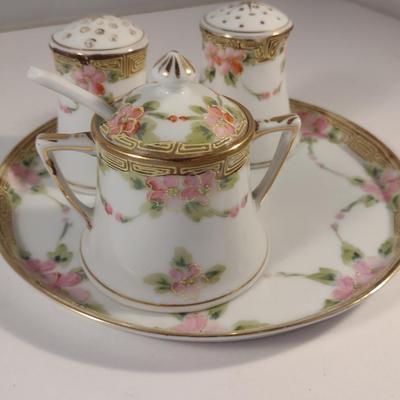 Sale Photo Thumbnail #475: Vintage Hand Painted Nippon Condiment Set- Seven Pieces.  Cup has chipping at rim- please see all pictures for condition.