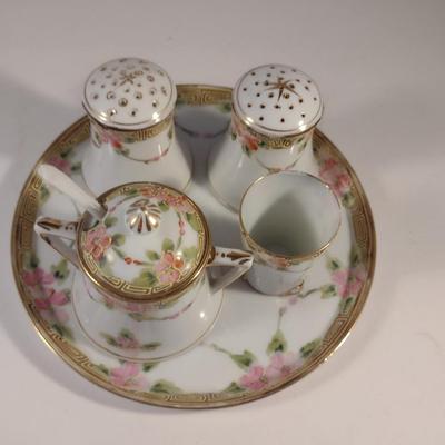 Sale Photo Thumbnail #474: Vintage Hand Painted Nippon Condiment Set- Seven Pieces.  Cup has chipping at rim- please see all pictures for condition.