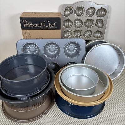 LOT 95: Bakers Delight: Pamper Chef Cookie Press, Longaberger Yellow Pie Plate, Spring Form Pan, Autum Cake-lite Pan, Wilton Round Pans,...