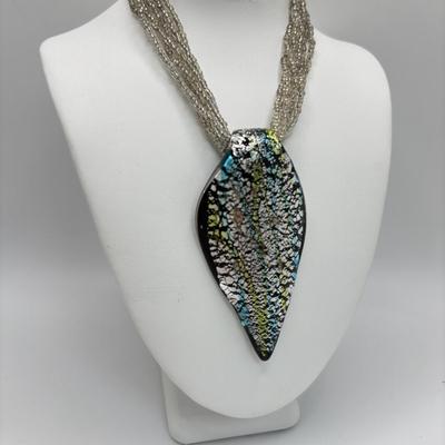 LOT 104: Beaded Necklace Collection Featuring an Art Glass Pendant along with 2 Pair of Dangle Earrings