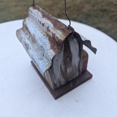 Small hanging birdhouse with metal roof