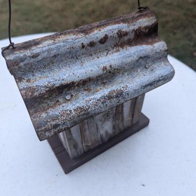 Small hanging birdhouse with metal roof