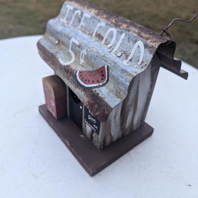 Small hanging birdhouse with metal roof