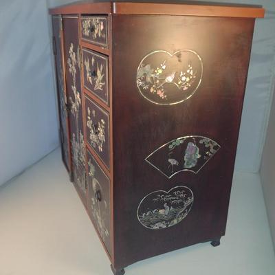 Sale Photo Thumbnail #570: Antique Chinese Wooden Storage Box with Mother of Pearl Inlay- Approx 17 1/2" x  8 3/4" x 16" Tall.  Back is drilled for possible wall hanging.  One foot/leg needs repair- please see all pictures for condition.