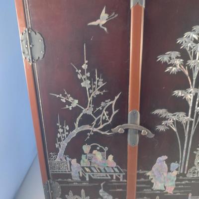 Sale Photo Thumbnail #562: Antique Chinese Wooden Storage Box with Mother of Pearl Inlay- Approx 17 1/2" x  8 3/4" x 16" Tall.  Back is drilled for possible wall hanging.  One foot/leg needs repair- please see all pictures for condition.