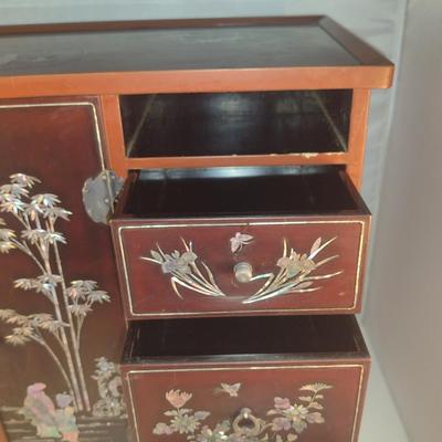 Sale Photo Thumbnail #569: Antique Chinese Wooden Storage Box with Mother of Pearl Inlay- Approx 17 1/2" x  8 3/4" x 16" Tall.  Back is drilled for possible wall hanging.  One foot/leg needs repair- please see all pictures for condition.