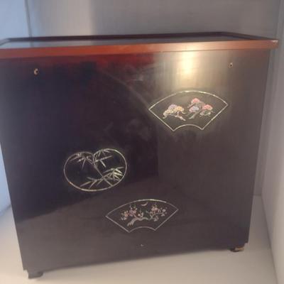 Sale Photo Thumbnail #573: Antique Chinese Wooden Storage Box with Mother of Pearl Inlay- Approx 17 1/2" x  8 3/4" x 16" Tall.  Back is drilled for possible wall hanging.  One foot/leg needs repair- please see all pictures for condition.