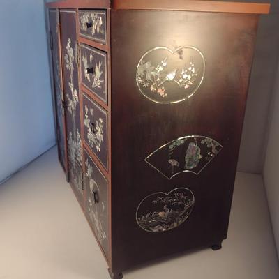 Sale Photo Thumbnail #571: Antique Chinese Wooden Storage Box with Mother of Pearl Inlay- Approx 17 1/2" x  8 3/4" x 16" Tall.  Back is drilled for possible wall hanging.  One foot/leg needs repair- please see all pictures for condition.