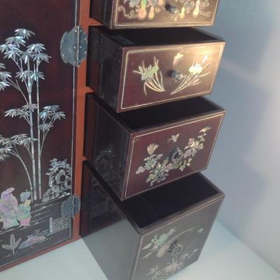 Sale Photo Thumbnail #568: Antique Chinese Wooden Storage Box with Mother of Pearl Inlay- Approx 17 1/2" x  8 3/4" x 16" Tall.  Back is drilled for possible wall hanging.  One foot/leg needs repair- please see all pictures for condition.