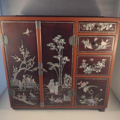 Sale Photo Thumbnail #560: Antique Chinese Wooden Storage Box with Mother of Pearl Inlay- Approx 17 1/2" x  8 3/4" x 16" Tall.  Back is drilled for possible wall hanging.  One foot/leg needs repair- please see all pictures for condition.