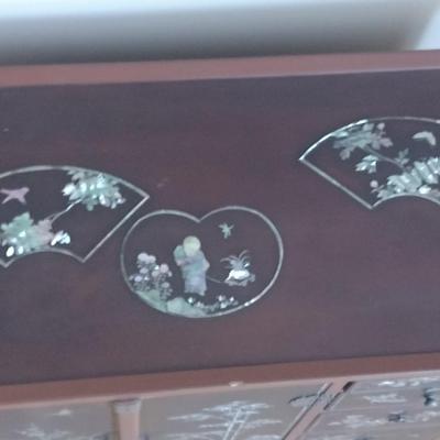 Sale Photo Thumbnail #581: Antique Chinese Wooden Storage Box with Mother of Pearl Inlay- Approx 17 1/2" x  8 3/4" x 16" Tall.  Back is drilled for possible wall hanging.  One foot/leg needs repair- please see all pictures for condition.