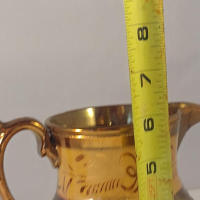 Sale Photo Thumbnail #610: Antique English Lusterware Pitcher- Copper Color with Cream Band- Approx 6" Tall.  Small chip on bottom of handle.
