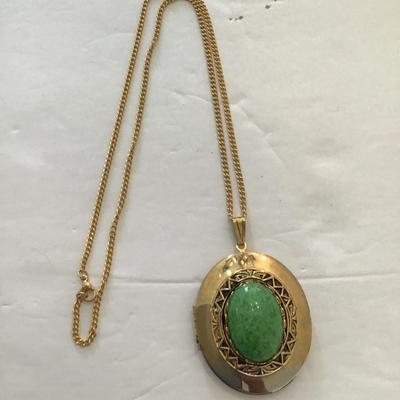 Sale Photo Thumbnail #17: Very nice gold tone, locket with polished green stone. Please see attached photos.