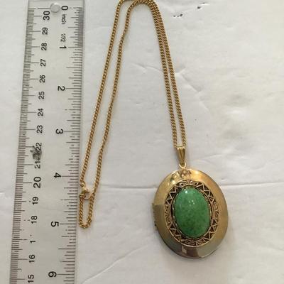 Sale Photo Thumbnail #18: Very nice gold tone, locket with polished green stone. Please see attached photos.