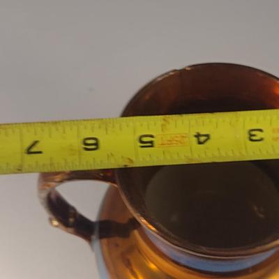 Sale Photo Thumbnail #624: Antique English Lusterware Pitcher- Copper Color with Blue Bands- Approx 6 1/2" Tall.  Item has chipping on rim and spout- please see all pictures.