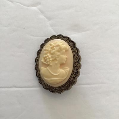 Sale Photo Thumbnail #44: Vintage plastic cameo brooch. Please see attached photos.