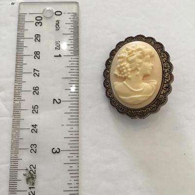 Sale Photo Thumbnail #45: Vintage plastic cameo brooch. Please see attached photos.