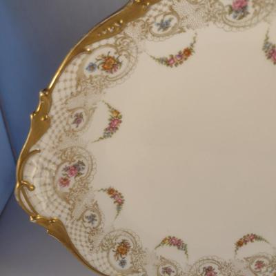 Sale Photo Thumbnail #711: Limoges France Porcelain Gilt Serving Plate- Approx 13 1/4" in Diameter.  Plate stand not included.