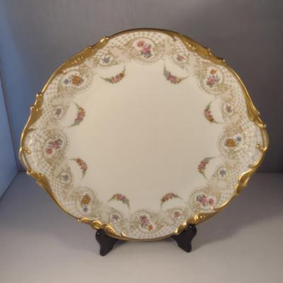 Sale Photo Thumbnail #709: Limoges France Porcelain Gilt Serving Plate- Approx 13 1/4" in Diameter.  Plate stand not included.
