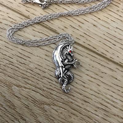 Dragon, red crystal eyes, and a crystal ball pendant necklace. Very nice silver tone, chain necklace.