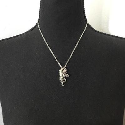 Dragon, red crystal eyes, and a crystal ball pendant necklace. Very nice silver tone, chain necklace.