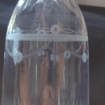 Sale Photo Thumbnail #803: Art Glass Decanter with Stopper- Etched Dainty Design- Approx 10 3/4" Tall.  Stopper has chipping.