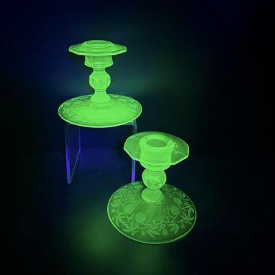 Sale Photo Thumbnail #336: 2 Green depression uranium glass candlesticks excellent condition.
Circa 1930s  Glows under blacklight.
4 inches tall, 4.75 inches wide