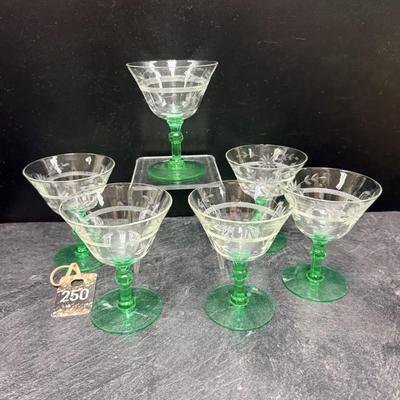 Sale Photo Thumbnail #338: Circa 1930s, green stem, etched glass
Set of 6.   2 have one  minor 'flea bite' on the rim 
4.5 inches tall by 3.5 inch diameter
