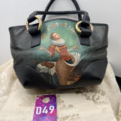 Sale Photo Thumbnail #367: Leather purse with painted woman juggling cards on both sides.
Magnetic closure, zipper pocket, 2 interior pockets gently used
11 inchs wide by 6 inches deep