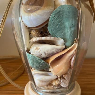 Sale Photo Thumbnail #251: Pair of clear glass ginger jar lamps filled with sea shells.   22” tall