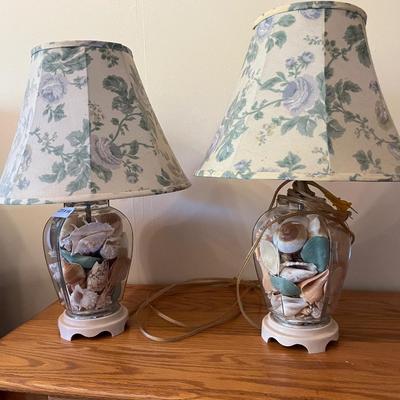 Sale Photo Thumbnail #253: Pair of clear glass ginger jar lamps filled with sea shells.   22” tall