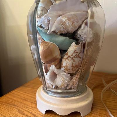 Sale Photo Thumbnail #252: Pair of clear glass ginger jar lamps filled with sea shells.   22” tall