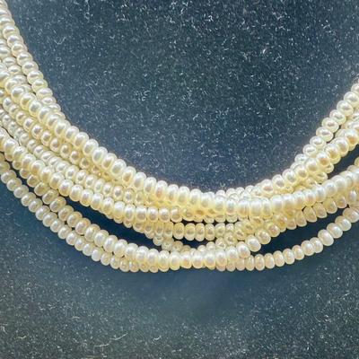 Sale Photo Thumbnail #54: 8-strand freshwater seed pearl necklace with a 14K gold clasp. Clasp is marked "ADPG" and "14K". Overall necklace weight is 55g.  Excellent condition.
