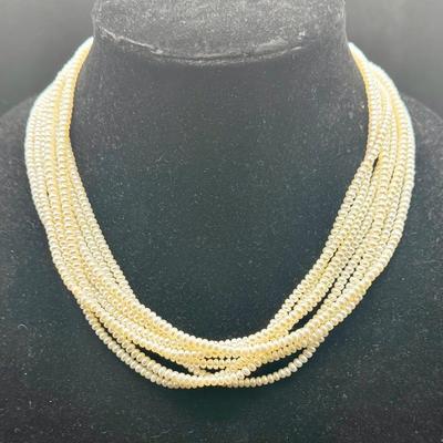 Sale Photo Thumbnail #53: 8-strand freshwater seed pearl necklace with a 14K gold clasp. Clasp is marked "ADPG" and "14K". Overall necklace weight is 55g.  Excellent condition.