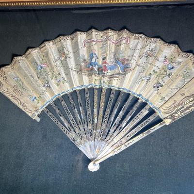 Sale Photo Thumbnail #393: Professionally framed, 25 x 29 3/4 inches
The top fan is Spanish origin, the bottom fan is French.  
Amazing hand painted antique fans, you will be stunned at the details.

The Spanish fan is likely from the 18th or 19th century, featuring carved and pier