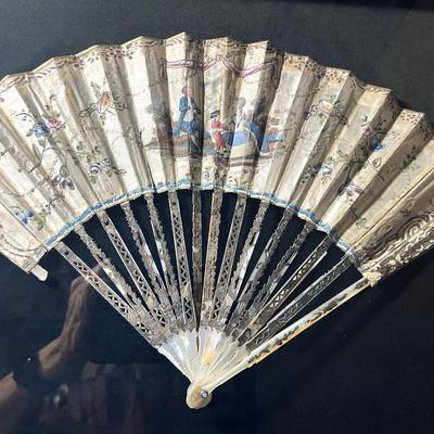 Sale Photo Thumbnail #392: Professionally framed, 25 x 29 3/4 inches
The top fan is Spanish origin, the bottom fan is French.  
Amazing hand painted antique fans, you will be stunned at the details.

The Spanish fan is likely from the 18th or 19th century, featuring carved and pier