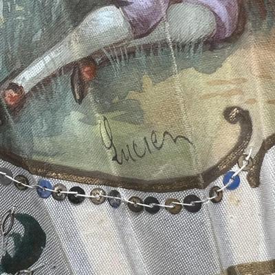 Sale Photo Thumbnail #395: A folding hand fan, antique, in a shadow box frame   Mother of pearl on the  sticks with the scene likely painted on silk or similar material. The sticks are likely bone, carved and pierced.  Signed by Lucien. Shadow box is 20 3/4 x 12 inches.  
Retails a