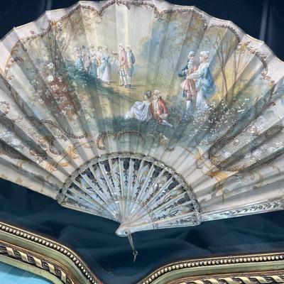 Sale Photo Thumbnail #404: Hand painted silk fan with etched mother of pearl, French courting  scene.  In a beautiful gold tone shadowbox, 23 x 15 inches.  
Retails at $300-$500